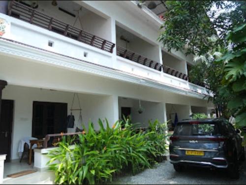 a car parked in front of a building at Mad about Coco Yoga & Beach Retreat in Varkala