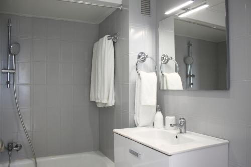 a white bathroom with a sink and a shower at Polo Apartments 8B in Marbella