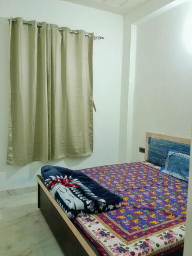 a bedroom with a bed with a blanket on it at Kishore villa fully furnished house in Jaipur
