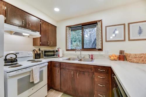 a kitchen with a sink and a stove top oven at Fern Hill Retreat in Chehalis