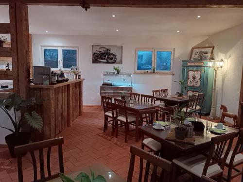 a restaurant with tables and chairs and a motorcycle on the wall at Franzl Hof Zorell in Ravensburg