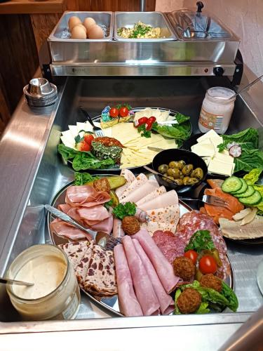 a tray of food with meats and vegetables on a counter at Franzl Hof Zorell in Ravensburg