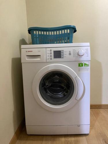 a washing machine with a basket on top of it at Guest House Laci in Tirana