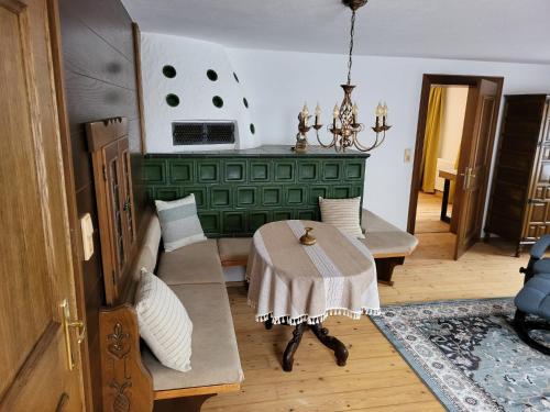 a living room with a table and a couch at AlpApart Hornberg in Hofen