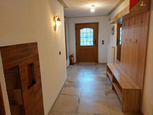a hallway with a door and a tile floor at AlpApart Hornberg in Hofen