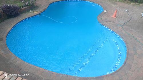 una piscina con agua azul en el medio en EYEZULU Guesthouse en Pinetown