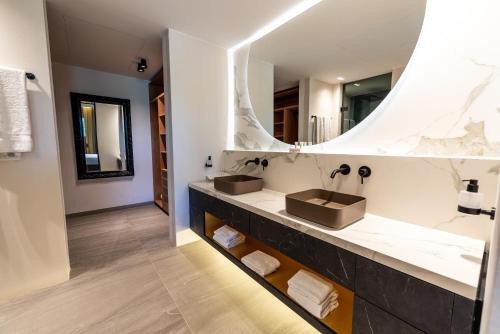 a bathroom with two sinks and a large mirror at Blue Bay Curaçao Golf & Beach Resort in Willemstad