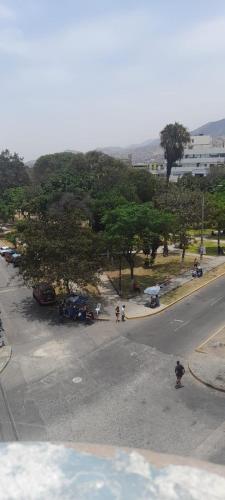 una calle con un aparcamiento con árboles y una boca de incendios en Plaza inn en Lima