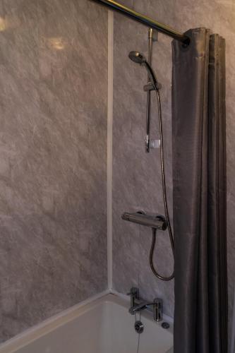 a shower in a bathroom with a shower curtain at The lodge at Carlton tavern free parking in York