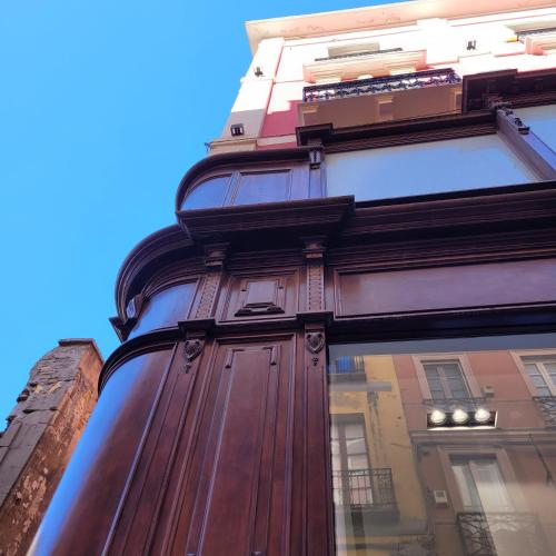 a tall building with a large wooden door at Palazzo Ferrucci Luxury Suites in Cagliari