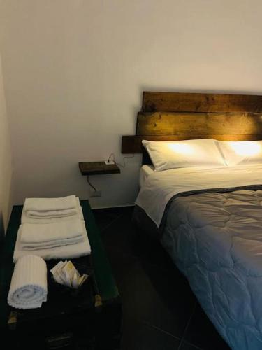 a bedroom with a bed and a table with towels at La Casa del Capo - appartamento con 2 camere. in Venaria Reale