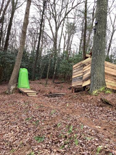 a green object is sitting in the woods at GLAMPING Off Grid Tent ULTIMATE IN COMFORT in Turtletown
