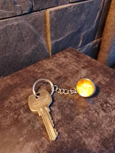 a key chain on top of a table at Zaciszny Zakątek Zawoja in Zawoja