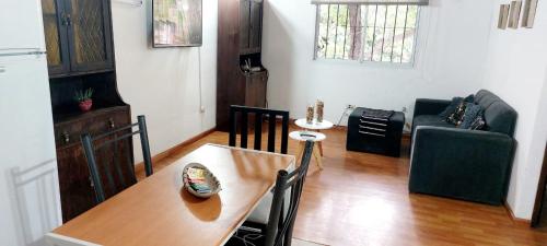 a living room with a table and a couch at DEPARTAMENTO COMPLETO 4 Pers Mza in Las Heras