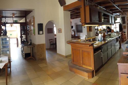 a large kitchen with a large island in a room at Landgasthof-Hotel Lichterhof in Uffenheim