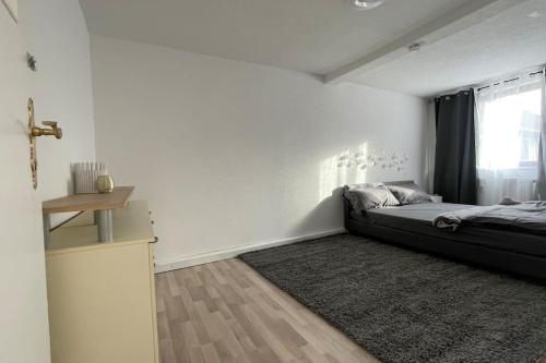 a bedroom with a bed and a window and a rug at Ferienwohnung Nappen platz in Bad Salzungen