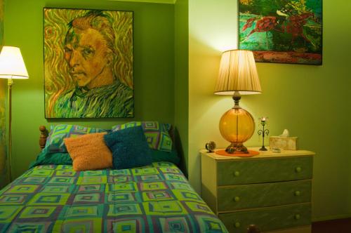a bedroom with a bed and a painting on the wall at The Inn at Castle Rock in Bisbee