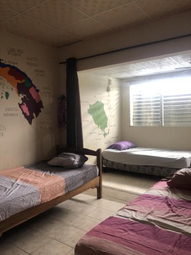 a room with two bunk beds and a window at The Green House in Bocas del Toro