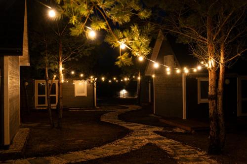 a string of lights on a house at night at Gorzewo Pora Relaksu in Gorzewo