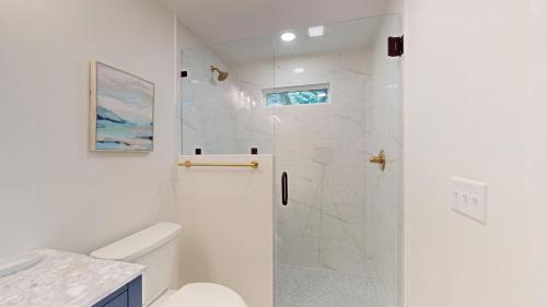 a white bathroom with a shower and a toilet at 79 Port Tack in Hilton Head Island