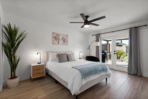 a white bedroom with a bed and a ceiling fan at Tempe Modern Farmhouse in Tempe