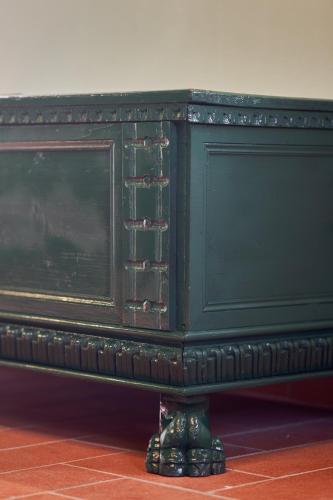 a green dresser with a black top sitting on a floor at Podere Sant'Antonio in Asciano