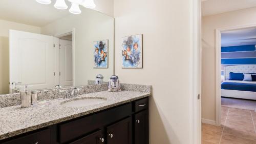 a bathroom with a sink and a mirror at Windsor At Westside Superpower 8801 in Kissimmee