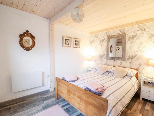 a bedroom with a large bed in a room at Chalet Forte in Aberdyfi