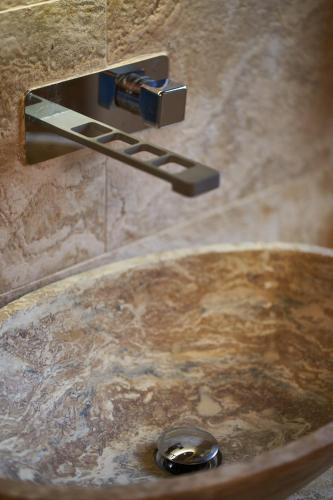 a bathroom sink with a water faucet at Podere Sant'Antonio in Asciano
