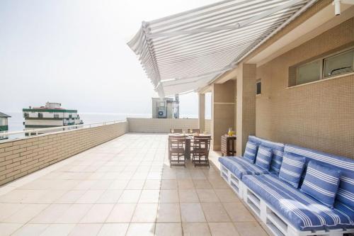 a balcony with blue benches and a table on a building at Sea View - Charming apartment in Vila do Conde