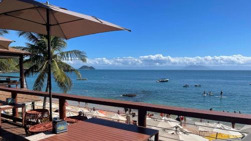 a view of a beach with people in the water at HOTEL VILLE LA PLAGE & BEACH CLUB in Búzios