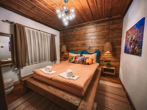 a bedroom with a bed with two towels on it at Кътче in Leshten