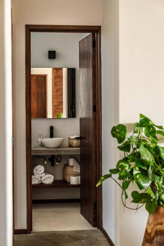 a bathroom with a sink and a mirror at La Barra Resorts Puerto Escondido in Puerto Escondido