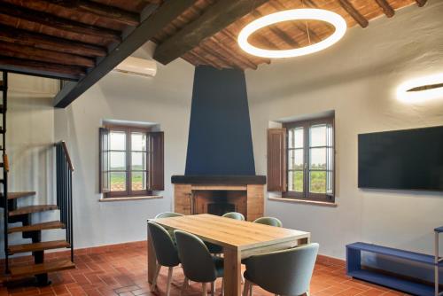 a dining room with a table and a fireplace at Podere Sant'Antonio in Asciano