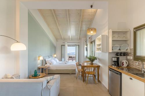 a kitchen and living room with a bed and a table at Callisto Seaside Homes & Suites in Marathopolis