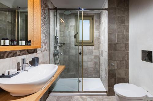 a bathroom with a sink and a shower at Callisto Seaside Homes & Suites in Marathopolis