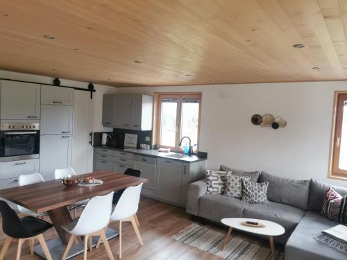 a kitchen and living room with a couch and a table at Bereuter in Sibratsgfäll