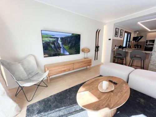 a living room with a white couch and a table at Ático Dúplex De Lujo - CLASIFICACIÓN 5 ESTRELLAS - 8PAX - A Pie Del Centro - 2 PARKINGS l by BonesVacances in Andorra la Vella