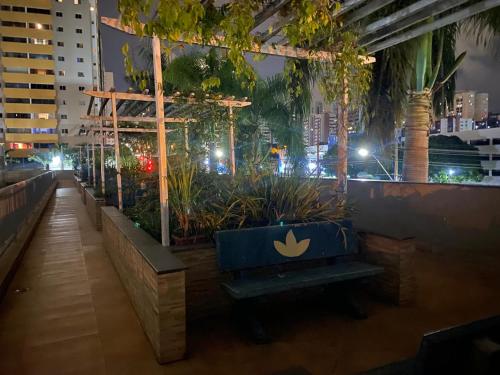 a bench in a city at night with lights at Apto Green Park Águas Claras apto 1526 in Águas Claras