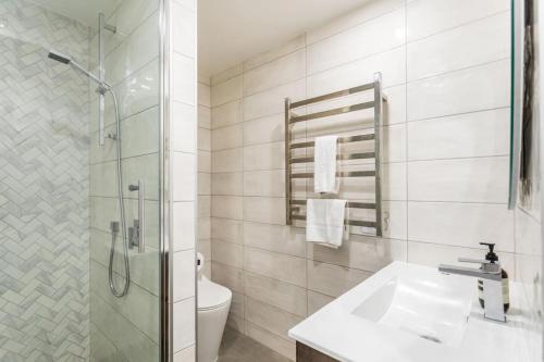 a bathroom with a shower and a sink and a toilet at City Fringe Crash Pad in Auckland