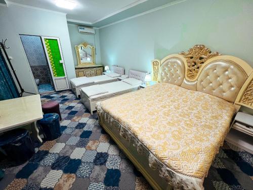 a bedroom with a large bed and a mirror at Hotel Uncle Kolya Boutique in Bukhara