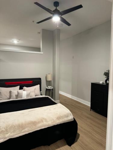 a bedroom with a bed and a ceiling fan at Towson Elite Apartment in Towson