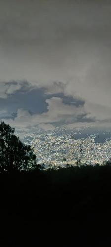 a view of a city from the top of a hill at Glamping SABIA con Wifi, fogata y vistas de Medellín in Santa Elena