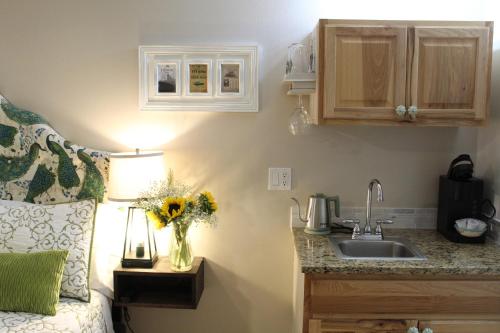 a kitchen with a sink and a vase of flowers at The Irish Inn in Hood River