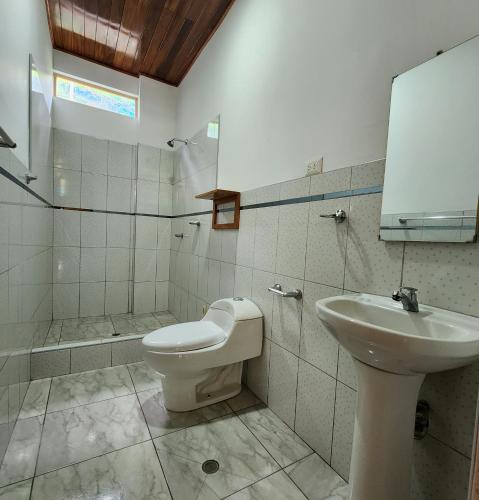 a bathroom with a toilet and a sink at Casa Piamonte in Pichanaki