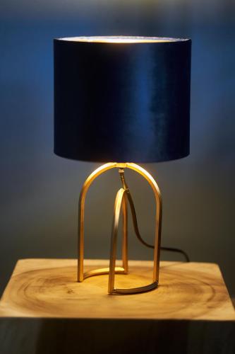 a gold lamp sitting on a wooden table at Podere Sant'Antonio in Asciano
