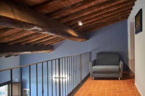 a chair sitting on a staircase in a room at Podere Sant'Antonio in Asciano