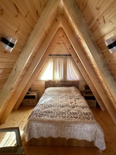 a bedroom with a bed in a attic at Cottage Rioni Kutaisi in Kutaisi