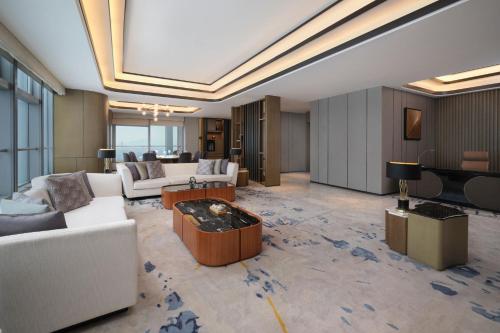 a large living room with couches and a piano at The Westin Wenzhou in Wenzhou