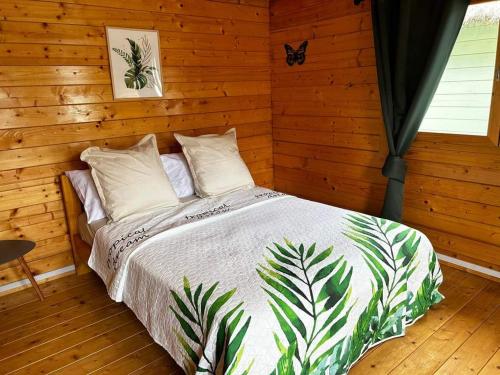 a bedroom with a bed in a wooden room at Chalets Chomoni 